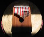 photo of a kalimba sitting atop a drum