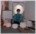 photo of Rahbi Crawford sitting surrounded by 8 crystal bowls