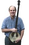 photo of Tom Rawson holding his banjo and smiling