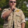 photo of Matt Southworth speaking into a microphone at an outdoor event