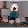 photo of Rahbi Crawford sitting surrounded by 8 crystal bowls