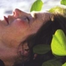 photo of Joanne Rand lying in the green leaves